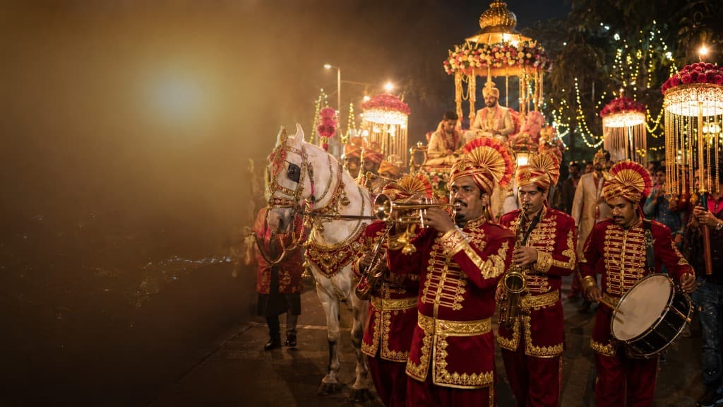 Baraat procession with wedding band, decorated horse and groom carriage